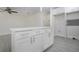 Modern kitchen island featuring white cabinets and drawers and white countertops at 1906 Canterbury Ln # 20, Sun City Center, FL 33573