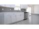 Bright kitchen features white cabinets, subway tile backsplash, stainless steel appliances, and an island at 1906 Canterbury Ln # 20, Sun City Center, FL 33573