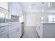 Bright kitchen features white cabinets, subway tile backsplash, stainless steel appliances, and an island at 1906 Canterbury Ln # 20, Sun City Center, FL 33573