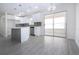 Bright kitchen features white cabinets, subway tile backsplash, stainless steel appliances, and an island at 1906 Canterbury Ln # 20, Sun City Center, FL 33573