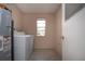 Bright laundry room featuring a modern washer, dryer and water heater, and wood-look tile floor at 1906 Canterbury Ln # 20, Sun City Center, FL 33573