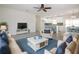 Bright open-concept living room with tile floors and a view of the kitchen and dining area at 1906 Canterbury Ln # 20, Sun City Center, FL 33573