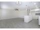 Open-concept living room with ceramic floors, ceiling fan, and kitchen with a breakfast bar at 1906 Canterbury Ln # 20, Sun City Center, FL 33573
