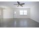 Well-lit living space with tile floors, ceiling fan, and lots of natural light at 1906 Canterbury Ln # 20, Sun City Center, FL 33573