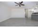 Open living space with tile flooring, neutral walls, ceiling fan, and an adjacent kitchen at 1906 Canterbury Ln # 20, Sun City Center, FL 33573