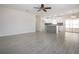 Open-concept living space with tile flooring, ceiling fan, and a gray tile kitchen island at 1906 Canterbury Ln # 20, Sun City Center, FL 33573