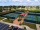 Aerial view of outdoor pickleball courts featuring vibrant green and blue surfaces plus covered seating at 1906 Canterbury Ln # 20, Sun City Center, FL 33573