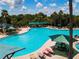 Stunning aerial view of a large pool, surrounded by palm trees and comfortable lounge chairs at 1906 Canterbury Ln # 20, Sun City Center, FL 33573