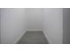 Clean walk-in closet features gray tile flooring and white walls for optimal organization at 1906 Canterbury Ln # 20, Sun City Center, FL 33573