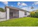 Landscaped backyard with green grass, a screened patio, and a well-maintained lawn of this single-Gathering residence at 19409 Weymouth Dr, Land O Lakes, FL 34638