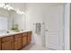 Bathroom featuring double sink vanity with ample counter space and lighting at 19409 Weymouth Dr, Land O Lakes, FL 34638