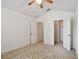 Bedroom with vaulted ceiling leading to a closet and another room with neutral colored carpet at 19409 Weymouth Dr, Land O Lakes, FL 34638