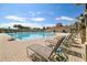 Large community pool with inviting lounge chairs and well maintained surroundings, offering the perfect place to relax at 19409 Weymouth Dr, Land O Lakes, FL 34638