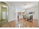 Open dining area with wood floors, modern light fixture, and arched doorway at 19409 Weymouth Dr, Land O Lakes, FL 34638