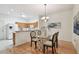 Dining area with wood floors and glass table at 19409 Weymouth Dr, Land O Lakes, FL 34638