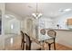 Open dining area with wood floors and glass table at 19409 Weymouth Dr, Land O Lakes, FL 34638