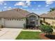 Charming single-Gathering home featuring a two-car garage and a beautifully landscaped front yard at 19409 Weymouth Dr, Land O Lakes, FL 34638
