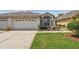 Charming home with a two-car garage, well-manicured lawn, and landscaped garden beds adding curb appeal at 19409 Weymouth Dr, Land O Lakes, FL 34638