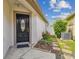 Elegant black front door with decorative glass, framed by lush landscaping at 19409 Weymouth Dr, Land O Lakes, FL 34638