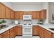 The kitchen features updated countertops, wooden cabinets, and modern appliances at 19409 Weymouth Dr, Land O Lakes, FL 34638