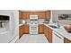 Bright kitchen boasts wooden cabinets, gas range, microwave and an undermount sink with updated countertops at 19409 Weymouth Dr, Land O Lakes, FL 34638