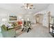 Bright living room with plush carpeting, ceiling fan, and neutral walls at 19409 Weymouth Dr, Land O Lakes, FL 34638