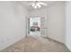 Bright room with carpet and french doors looking into living room at 19409 Weymouth Dr, Land O Lakes, FL 34638