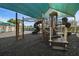 Large playground equipment with slides, stairs, and climbing features under a shaded canopy for outdoor fun at 19409 Weymouth Dr, Land O Lakes, FL 34638