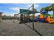 Community playground featuring colorful play structures, swings, and a soft ground covering for a safe play environment at 19409 Weymouth Dr, Land O Lakes, FL 34638