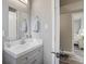 Bathroom featuring a vanity, quartz countertops, grey walls, and a view into the bedroom at 2018 Windsor Way, Tampa, FL 33619