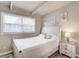Bright bedroom with wood flooring, white trim, and sunlit windows at 2018 Windsor Way, Tampa, FL 33619