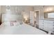 Bedroom with light walls, wood floors and a view into the ensuite bathroom at 2018 Windsor Way, Tampa, FL 33619