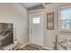 Bright entryway featuring a white door with glass panes, stylish decor, and light wood floors at 2018 Windsor Way, Tampa, FL 33619