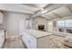 Open-concept kitchen and living area with a center island, stainless appliances, and plenty of natural light at 2018 Windsor Way, Tampa, FL 33619