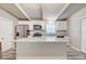 Modern kitchen with stainless steel appliances, a large island, and white cabinetry at 2018 Windsor Way, Tampa, FL 33619