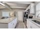 Well-lit kitchen with stainless steel appliances, a granite countertop island, and a view of the living room at 2018 Windsor Way, Tampa, FL 33619