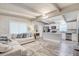 Open-concept living room and kitchen featuring modern decor, stainless appliances, and wood-look floors at 2018 Windsor Way, Tampa, FL 33619