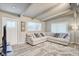 Comfortable living room with a large sectional sofa, decorative pillows, and a stylish area rug at 2018 Windsor Way, Tampa, FL 33619