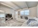 Cozy living space with a large sectional sofa, a modern TV stand, and a bright window at 2018 Windsor Way, Tampa, FL 33619