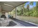 Covered patio with seating area and views of the private backyard at 2018 Windsor Way, Tampa, FL 33619
