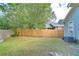 Backyard view of a fenced-in yard with a lawn, privacy fence, and a view of surrounding houses at 205 W Emma St, Tampa, FL 33603