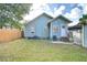 A fully fenced backyard featuring a well-maintained lawn and a charming exterior with a private entrance and lush landscaping at 205 W Emma St, Tampa, FL 33603