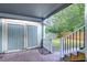 Backyard view of a covered patio with a partial lawn, privacy fence and a storage shed at 205 W Emma St, Tampa, FL 33603