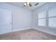Bedroom with two windows, carpet, ceiling fan and white walls at 205 W Emma St, Tampa, FL 33603