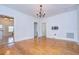 Large dining room with hardwood floors, classic chandelier, and access to other rooms creates a welcoming atmosphere at 205 W Emma St, Tampa, FL 33603