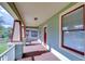 Spacious front porch featuring architectural columns, ample room for seating, and views of the neighborhood at 205 W Emma St, Tampa, FL 33603