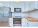 Kitchen with stainless steel appliances, white cabinets, and butcher block countertops at 205 W Emma St, Tampa, FL 33603