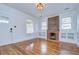 Bright living room features a brick fireplace, hardwood floors, and built-in shelving, enhancing its appeal at 205 W Emma St, Tampa, FL 33603
