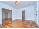 Open-concept living room with gleaming hardwood floors, classic lighting, and multiple entryways, perfect for entertaining at 205 W Emma St, Tampa, FL 33603