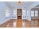 Elegant living room showcasing gleaming hardwood floors, a brick fireplace, and custom built-in shelving units at 205 W Emma St, Tampa, FL 33603